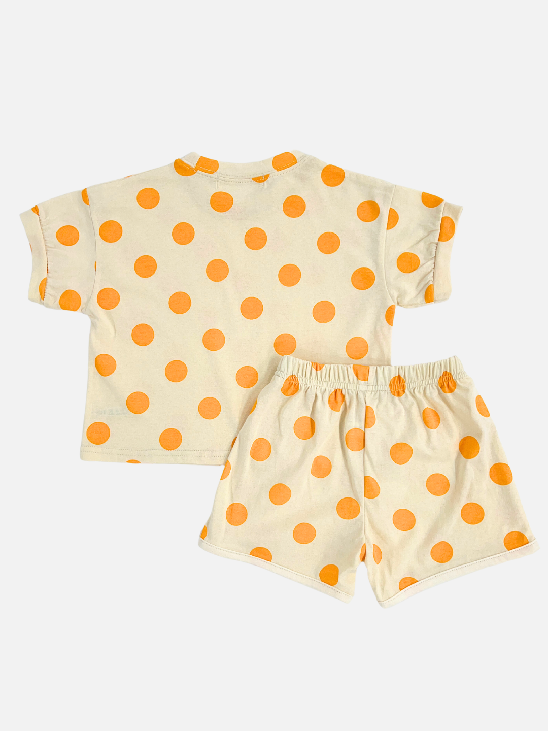 Orange | A kids' tee shirt and shorts set in a pattern of orange dots on an ecru background, back view