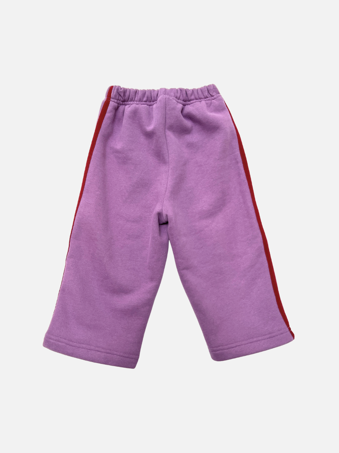 Grape | The SUNDAY TRACKPANTS are children's lavender cotton fleece pants with red side stripes, an elastic waistband, and wide legs, shown on a white background.