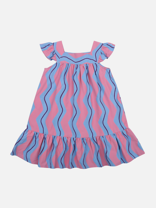 Image of Front of Wave Stripe Dress. Wide pink vertical squiggly stripes and thin purple vertical squiggly stripes on a light blue background. Ruffled hem and ruffled cap sleeve.
