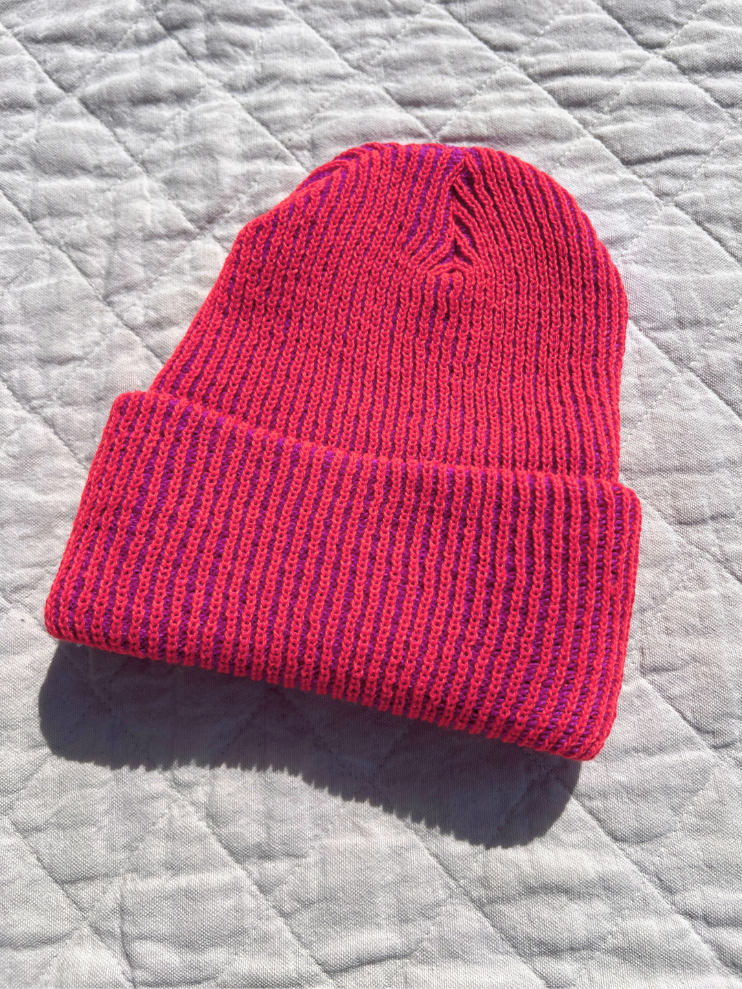 Poppy Magenta | Hat laid flat on the quilt