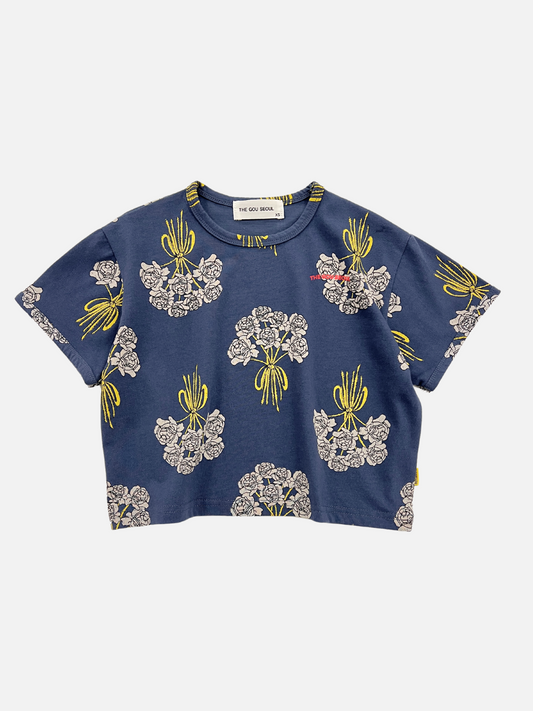 Image of Navy | A front view of the kids' Bouquet Tee in Navy. Navy background with white bouquets of roses all over. The Gou Should logo in red on the right side of the tee. 