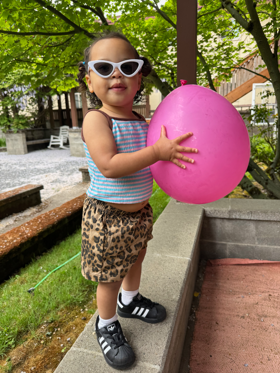 White | Child holding a pink balloon outdoors on a sunny day, wearing white cats eye sunglasses