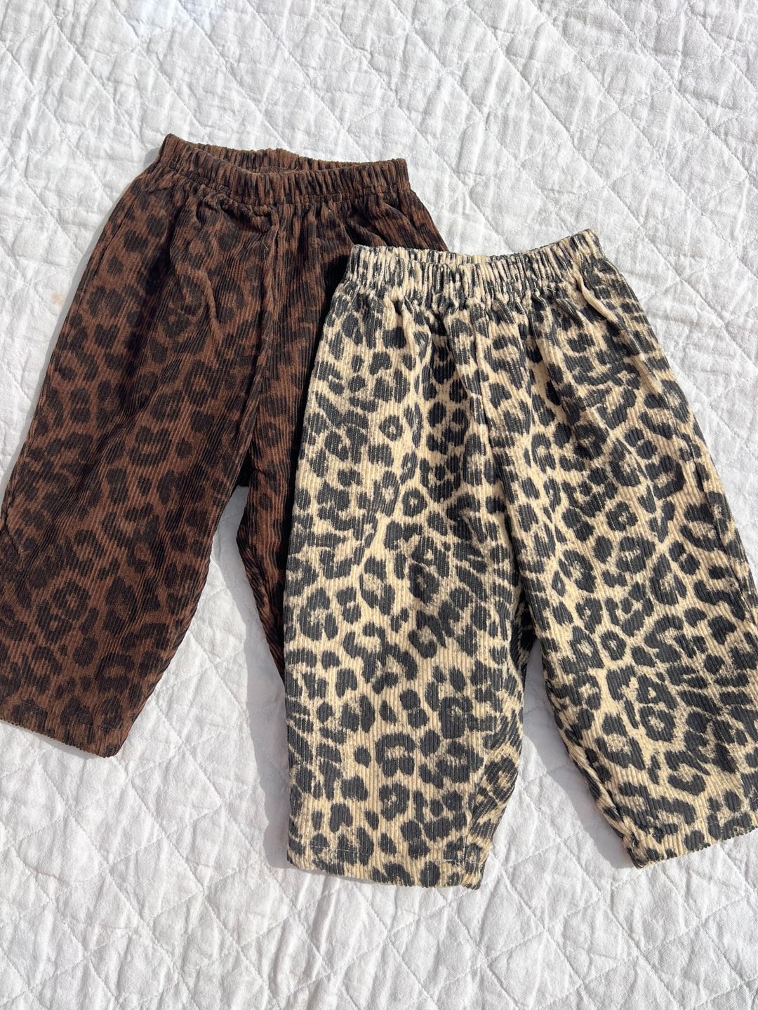 Two colorways of the leopard pants on a quilt