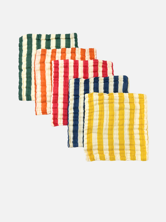 Image of ORGANIC BABY WASH CLOTHS—set of five soft muslin cotton squares with a textured surface and vertical stripes in green, orange, red, blue, and yellow—are ideal for bath time. Shown overlapped on a plain white background.