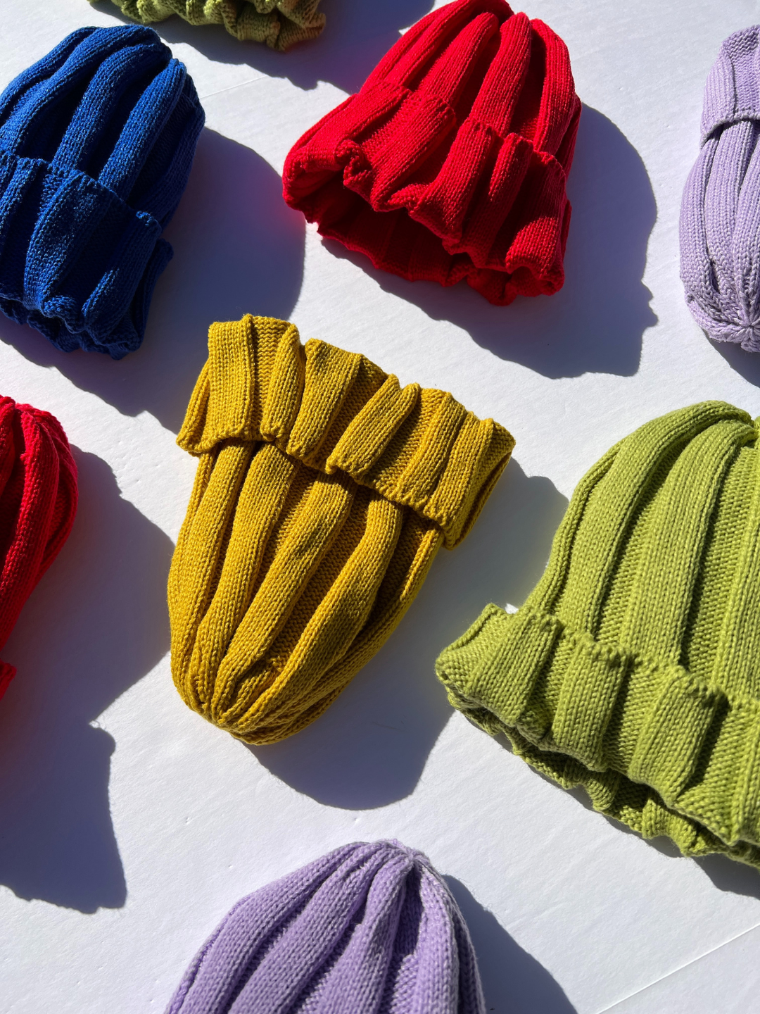 A selection of kids' kniited beanies in different colors