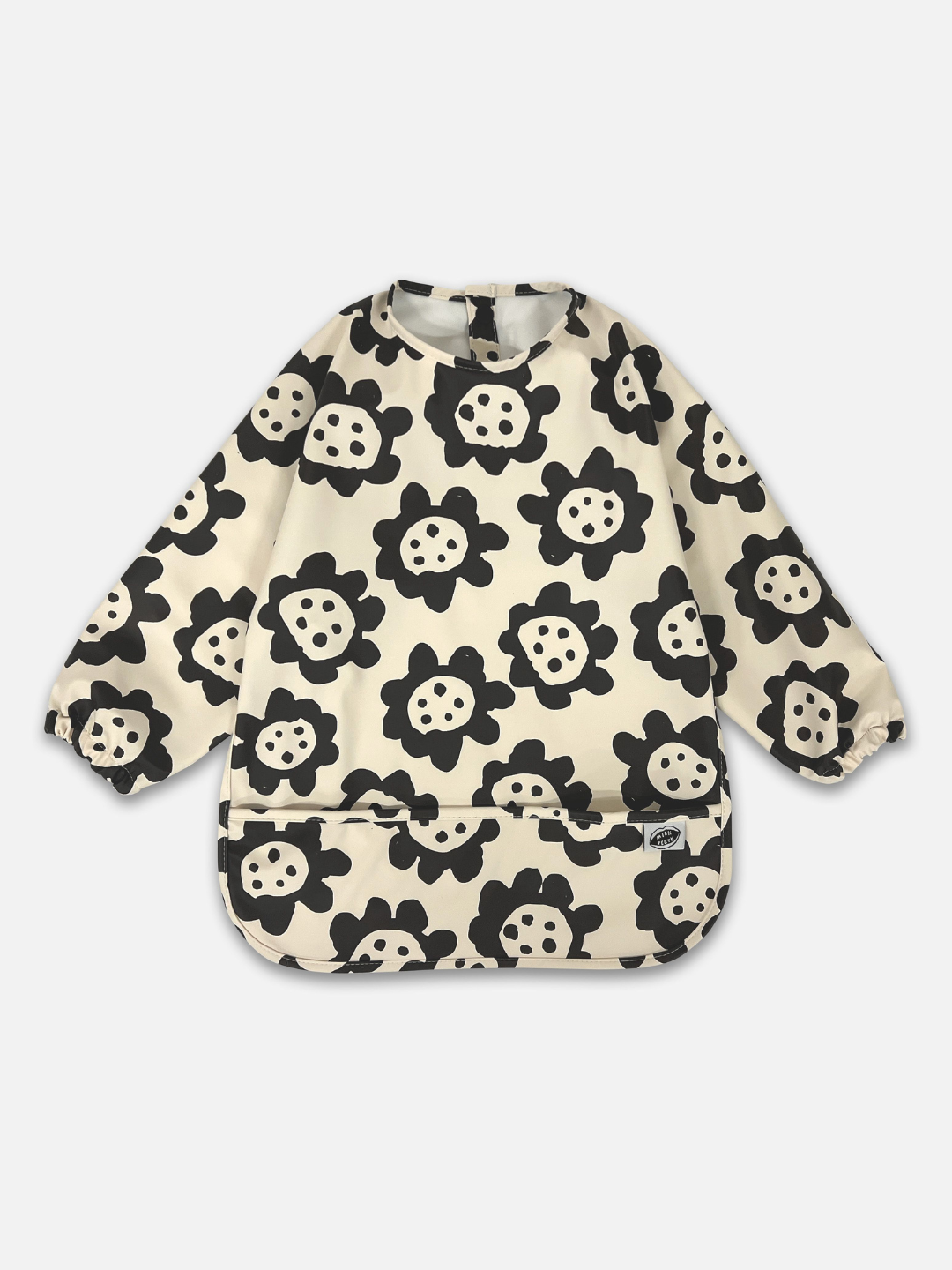 A front view of the long sleeve cream colored bib with black sunflowers and a front pocket.