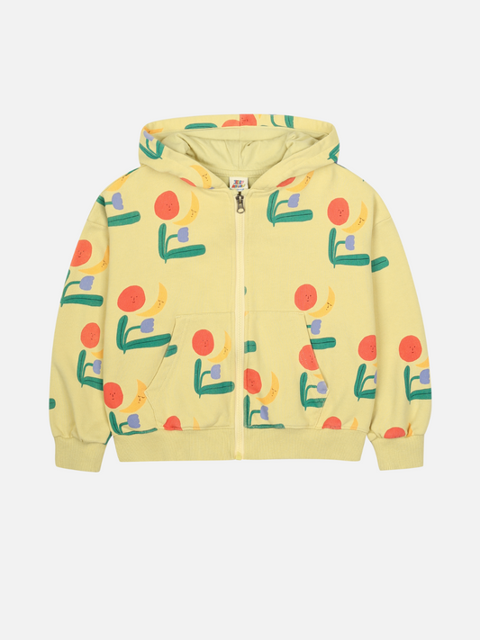 Image of The COLORED NATURE HOODIE ZIP UP is a light yellow hoodie with a zip-up front, colorful abstract floral patterns in red, yellow, green, and blue, plus a hood and front pocket.