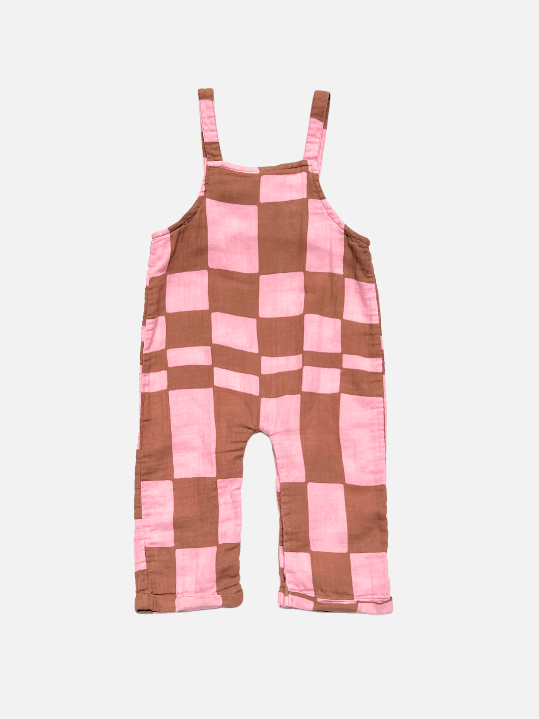 MUSLIN OVERALLS made from organic cotton with wide straps, showcasing a bold pink and brown checkered pattern, are displayed flat on a white background.