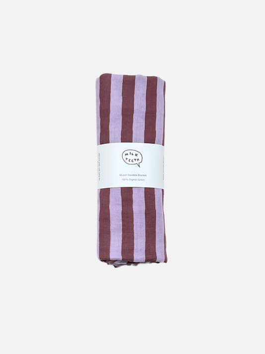 Image of Purple Stripe | A purple and maroon striped organic cotton swaddle is shown rolled up with a white Milk Teeth label around the middle, on a light grey background.