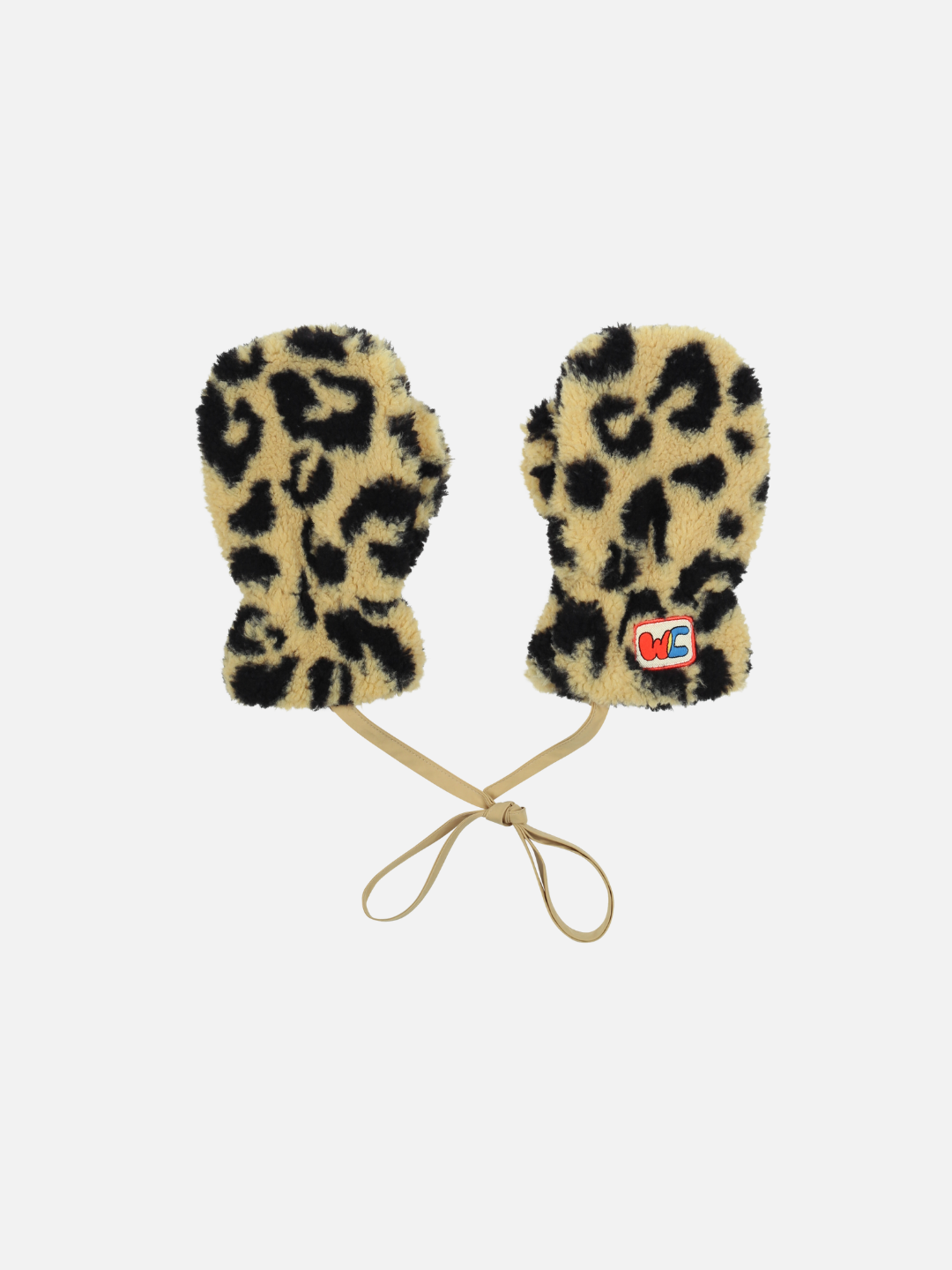 The LEOPARD PATCH MITTENS are a pair of leopard print mittens connected by a beige string, each adorned with a small embroidered red and blue patch on one mitten. The product description is thoughtfully crafted to include alt text for online accessibility, ensuring proper care and inclusivity in digital spaces.