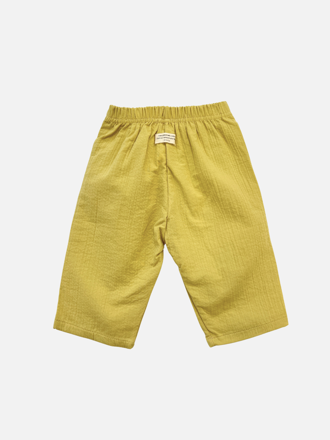 The CLOUD COTTON PANT in Honey, featuring a relaxed fit and elastic waistband, is laid flat on a white background, crafted from breathable woven cotton for comfort.