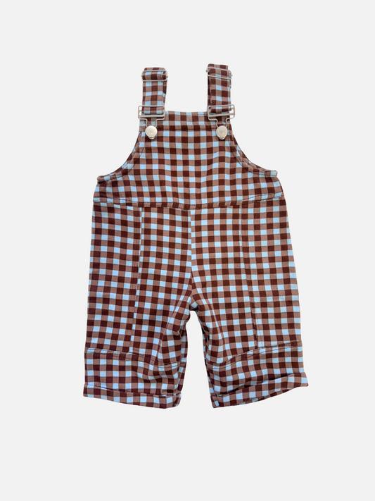Image of Brown and white checkered overalls with suspenders on a light gray background