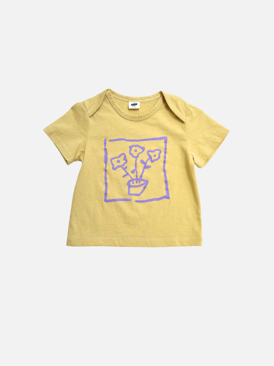 The FLOWER POT BABY TEE is a yellow short-sleeve shirt featuring a purple line drawing of three flowers in a pot inside a square on the front.