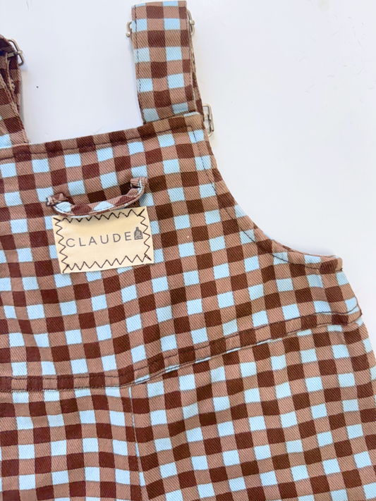 Second image of Brown and white checkered overalls with suspenders on a light gray background