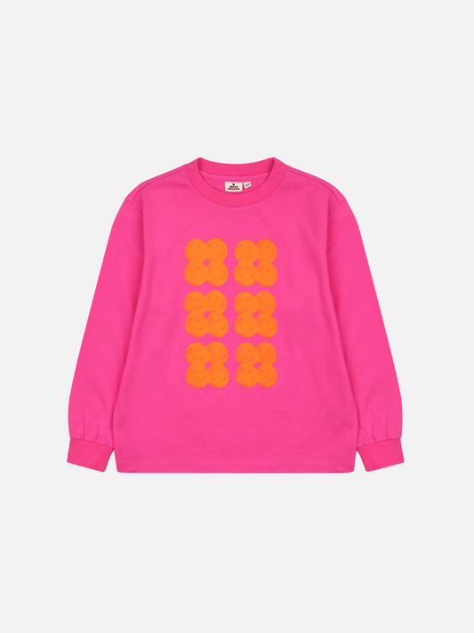 Image of Front of Clover Long Sleeve Tshirt. Hot pink long sleeve t-shirt with six bright orange clovers in two rows down the center front.