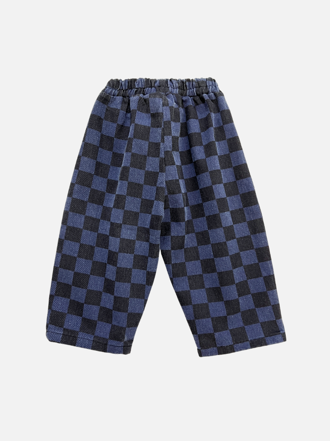 Blue | The CASPER PANTS are loose-fitting checkerboard cotton pants, crafted from sturdy cotton twill with an elastic waistband in a black and blue checkered pattern, ideal for unisex kidswear.