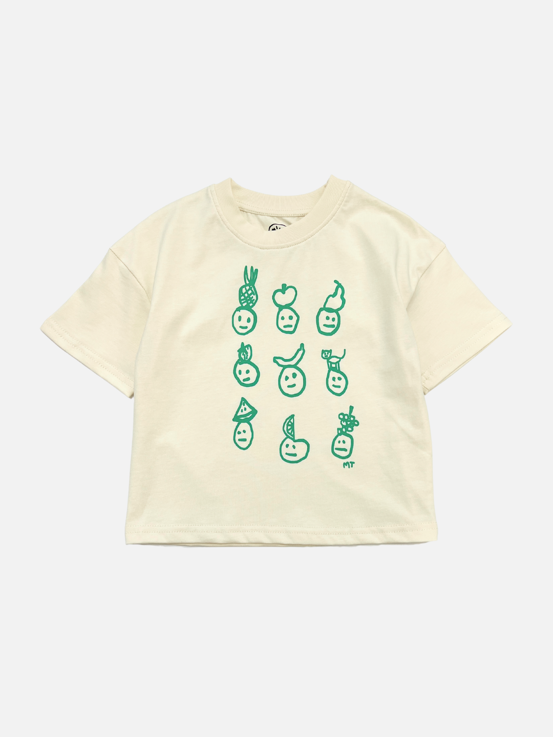 A front view of the kids' Fruit Face tee in Cream. Printed faces are wearing fruit hats, all in green color.