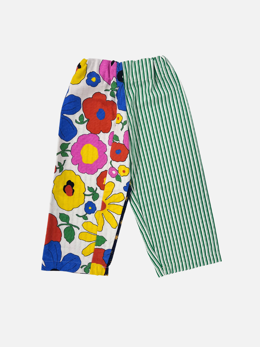 Front view of kid's patchwork pant. Left leg - big floral print. Right Leg - green stripe.