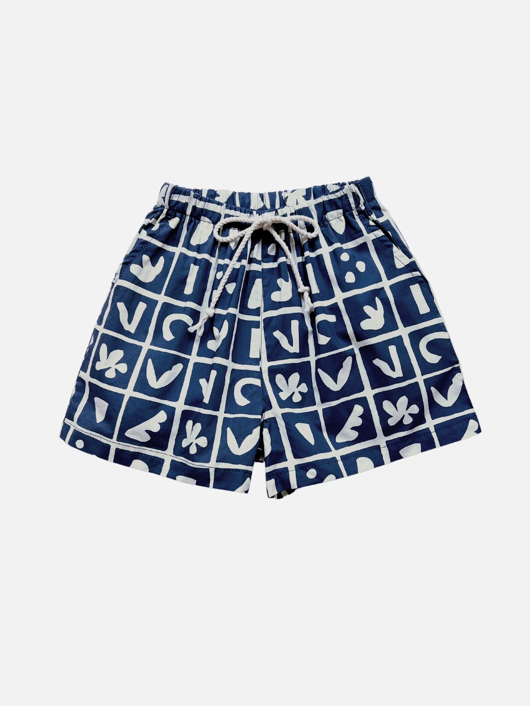 Blue | A pair of kids' shorts in deep blue, overlaid with a grid of different shapes in white