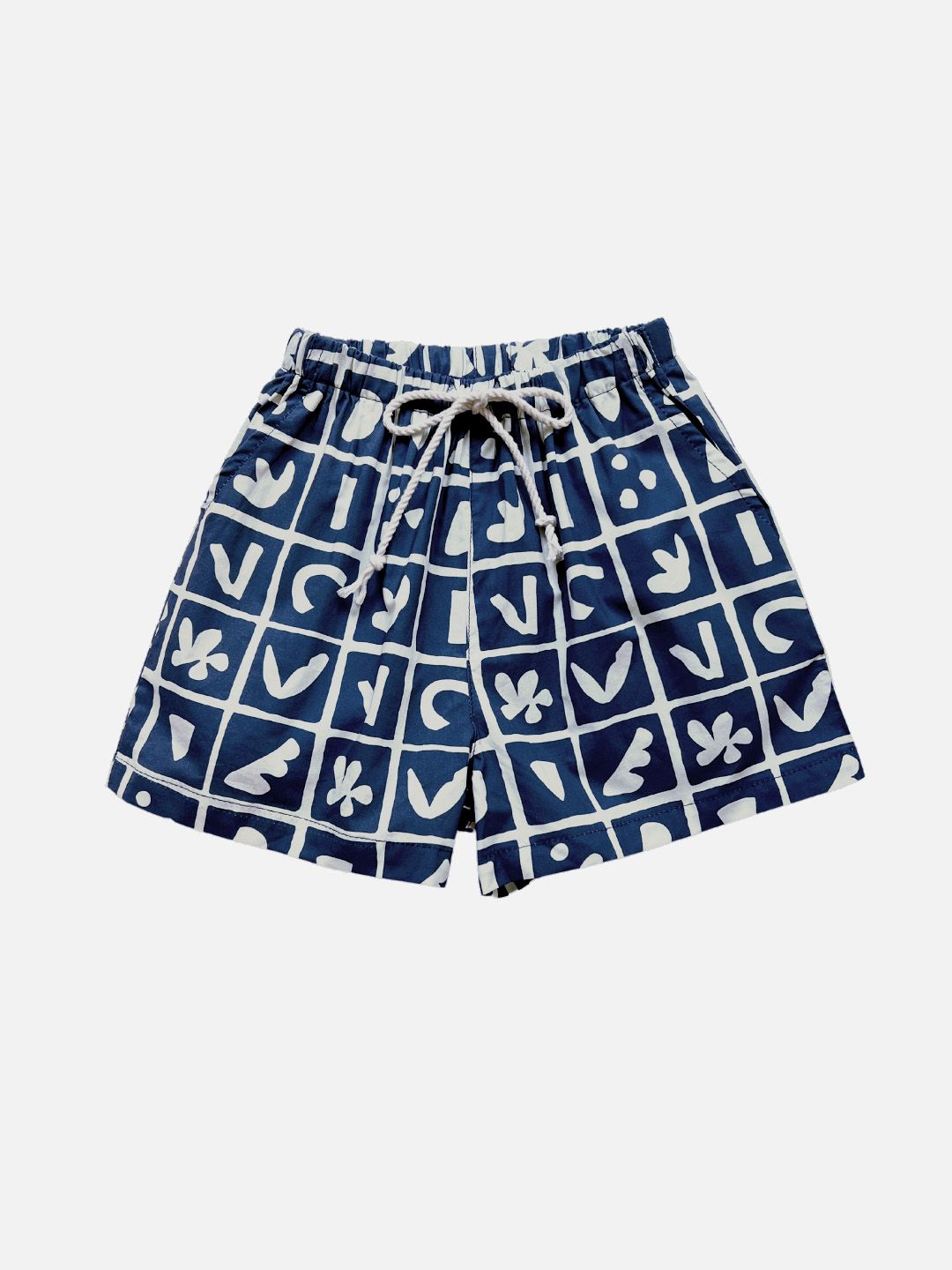 A pair of kids' shorts in deep blue, overlaid with a grid of different shapes in white