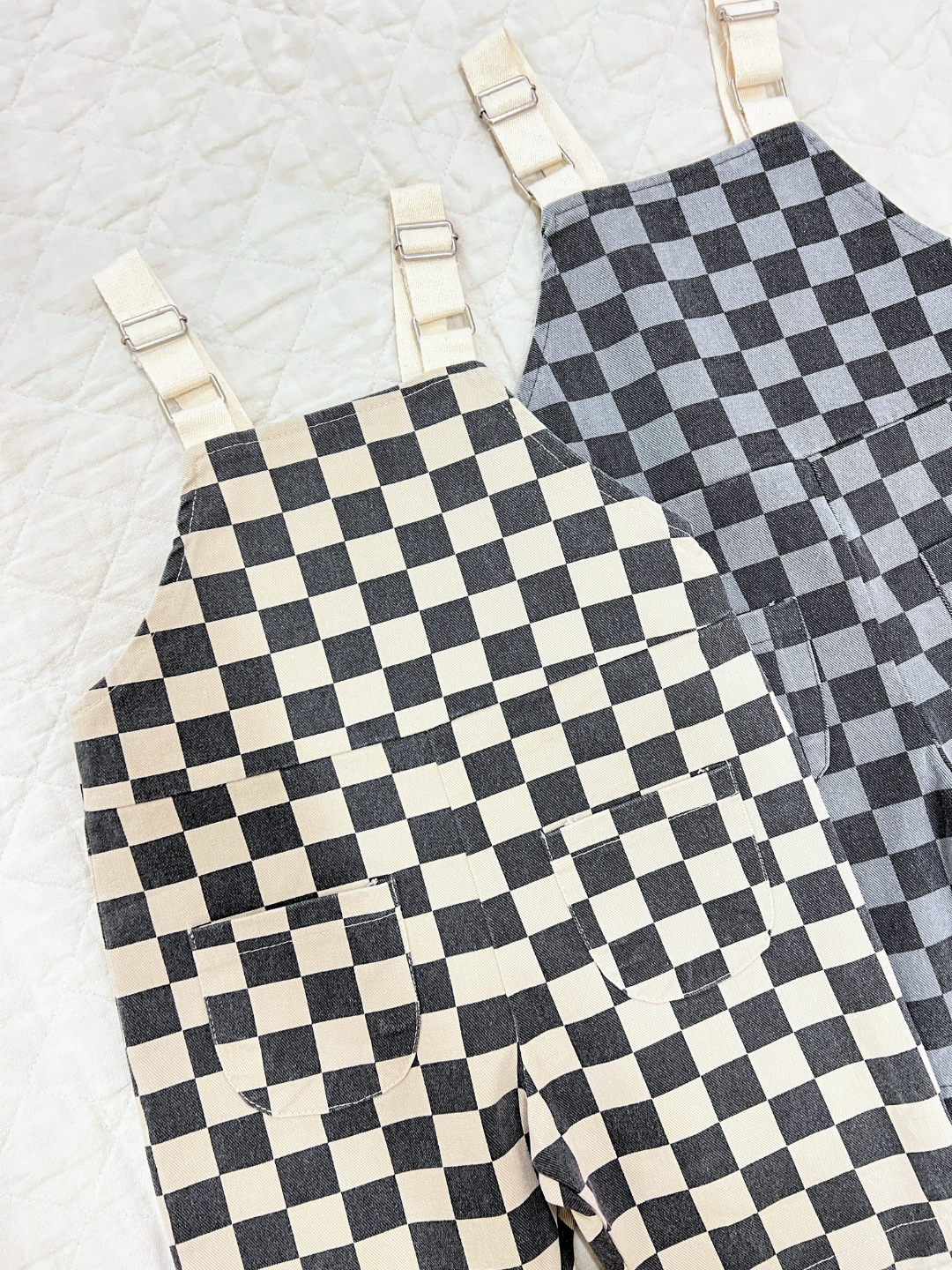 Off-White | Both colors of pull on checker overalls laid next to each other