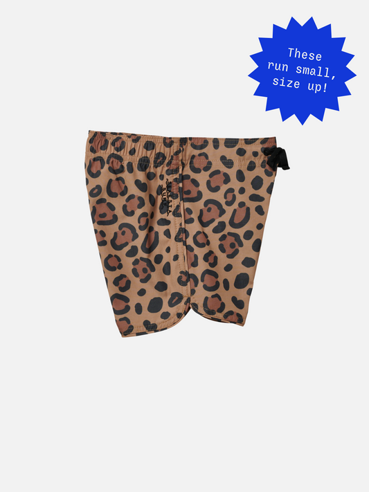 Second image of CALICO CRAB BOARDSHORTS showcase a vintage vibe with bold leopard print and black drawstring, complemented by a sleek scalloped hem on a crisp white background.