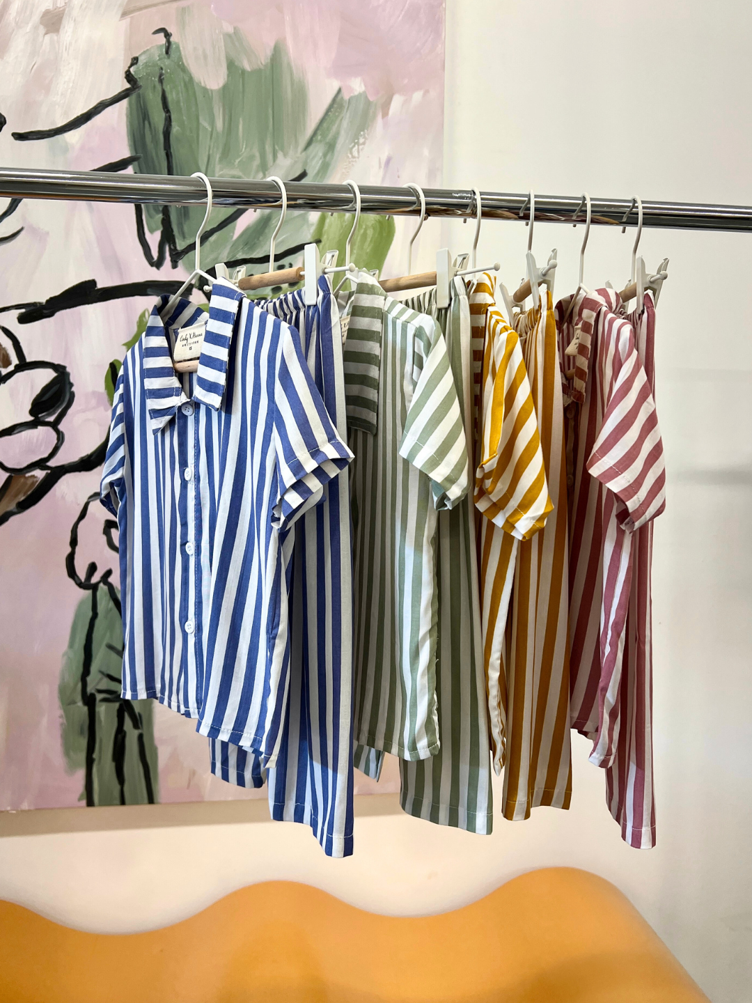 All colors of the kid's Michi Pajamas hanging on the rack