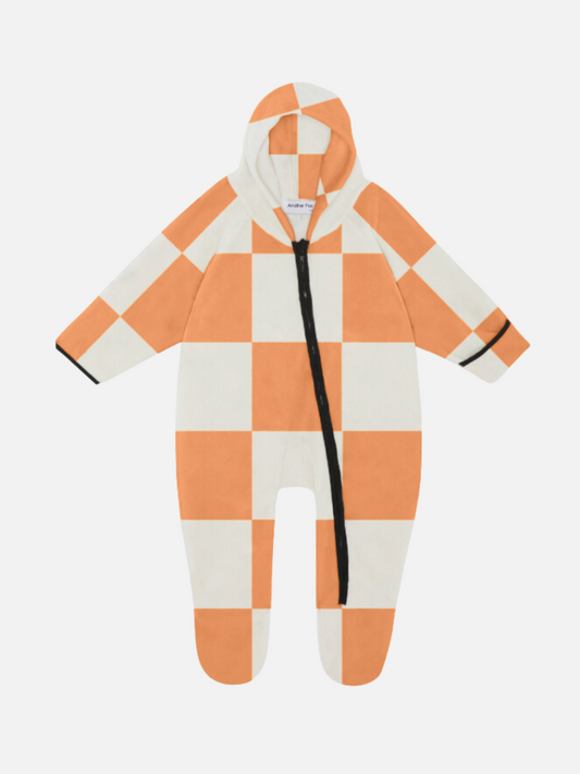 Image of A baby's one-piece hooded stroller suit in a bold apricot and white checkerboard pattern, front view