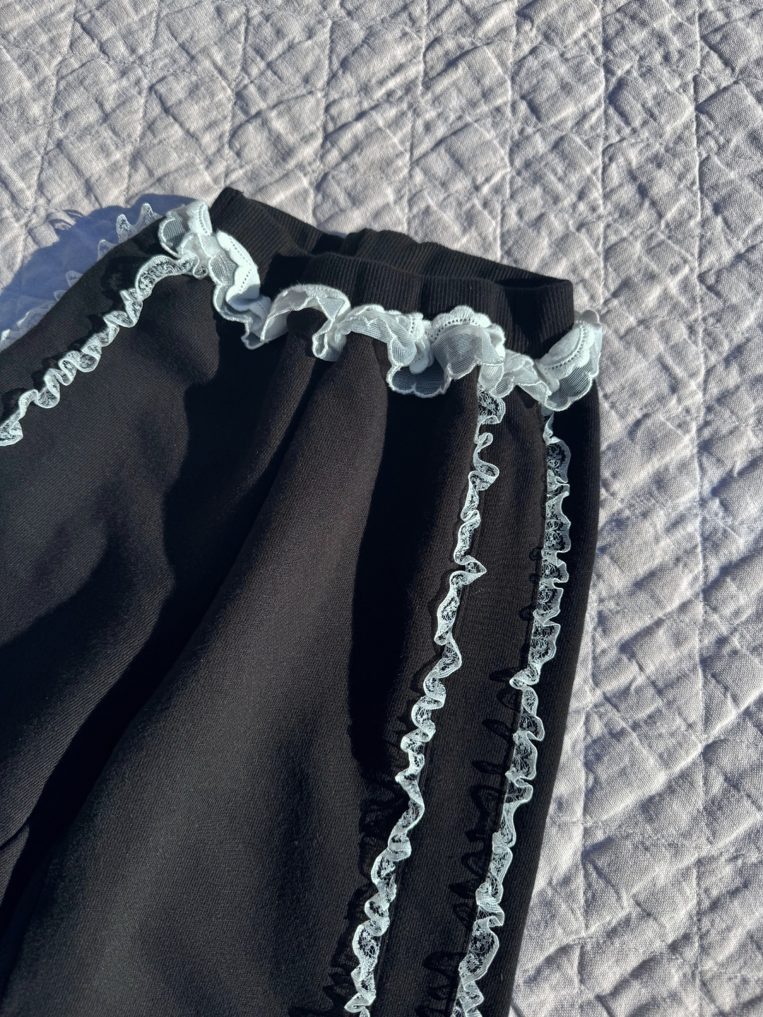 A close up on the ruffle detail of the Relay pant