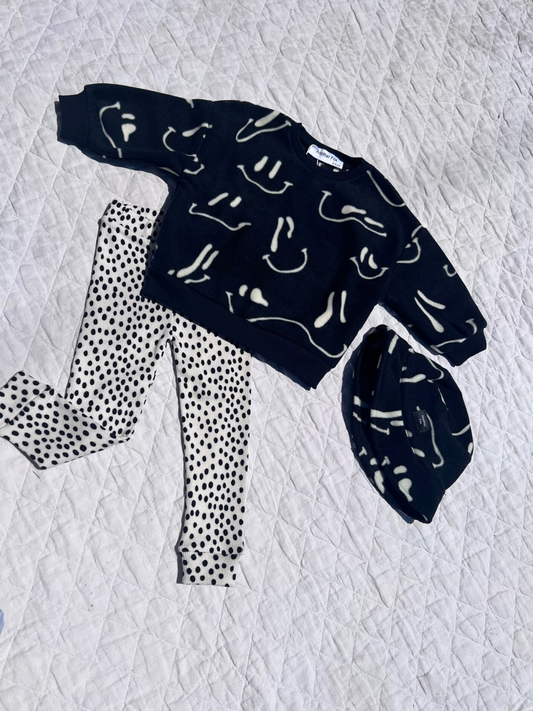 Second image of A pair of kids' leggings in a black and white mini cheetah dot print