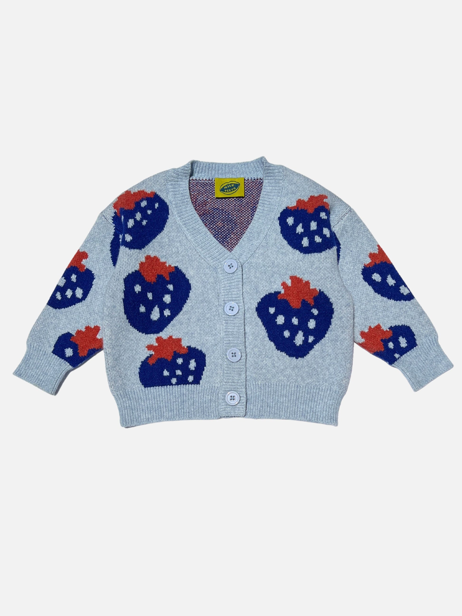 Front view of a kids v-neck cardigan in light blue with an all-over pattern of large blue strawberries with a red leaf. Cardigan has 4 buttons.