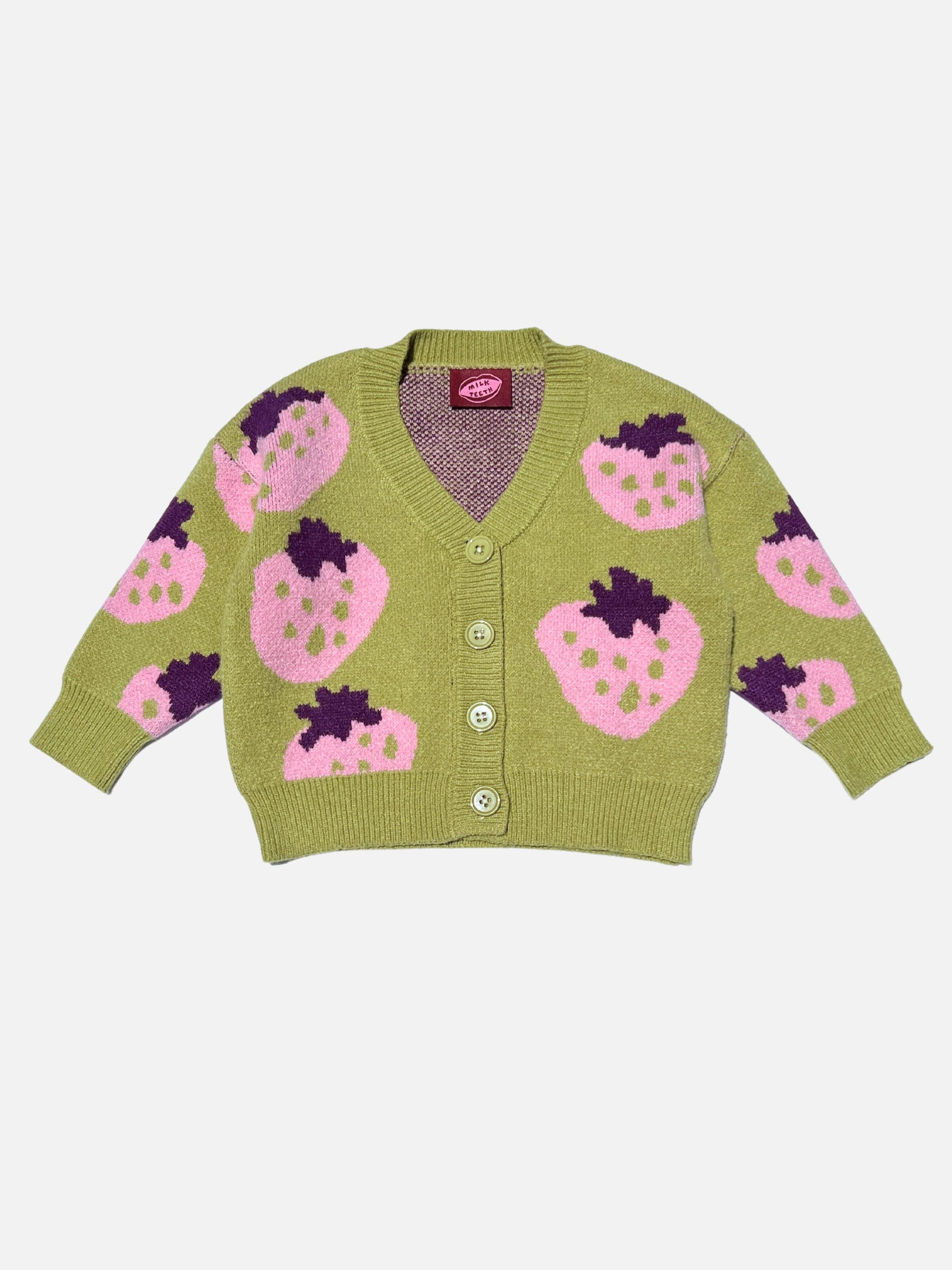 Front view of a kids v-neck cardigan in pistachio green with an all-over pattern of large pink strawberries with a purple leaf. Cardigan has 4 buttons.