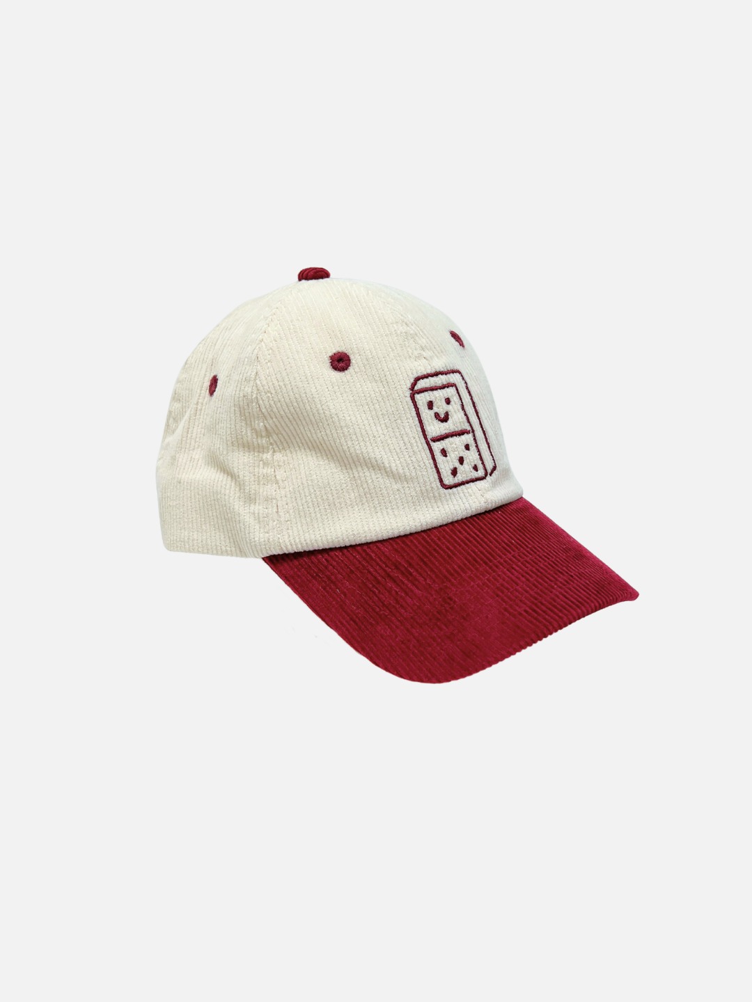 A two-tone kids baseball cap featuring an off-white corduroy crown and a dark red corduroy brim, with a matching red embroidered smiley domino graphic on the front.