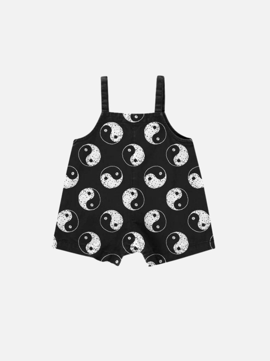 A front view of black overalls with a yin and yang pattern all over.
