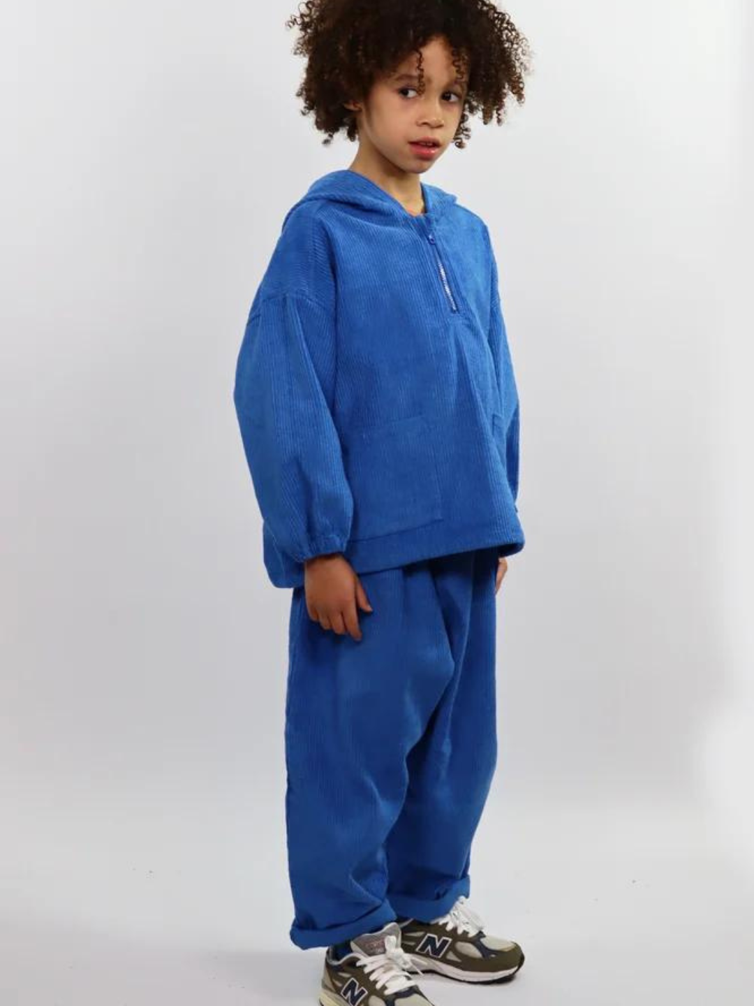 Child wearing blue kids' hooded smock and pants
