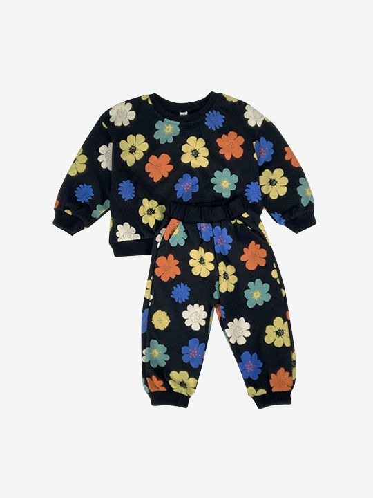 A kids' sweatshirt and pants set in black, printed with yellow, orange, green, blue and white flowers, front view