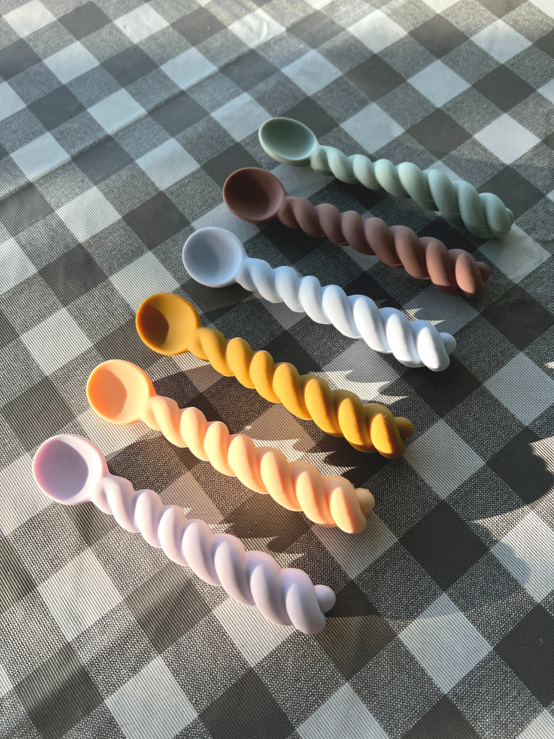 Lavender / Vanilla / Light Rubber | Six rubber kids spoons laid on tablecloth