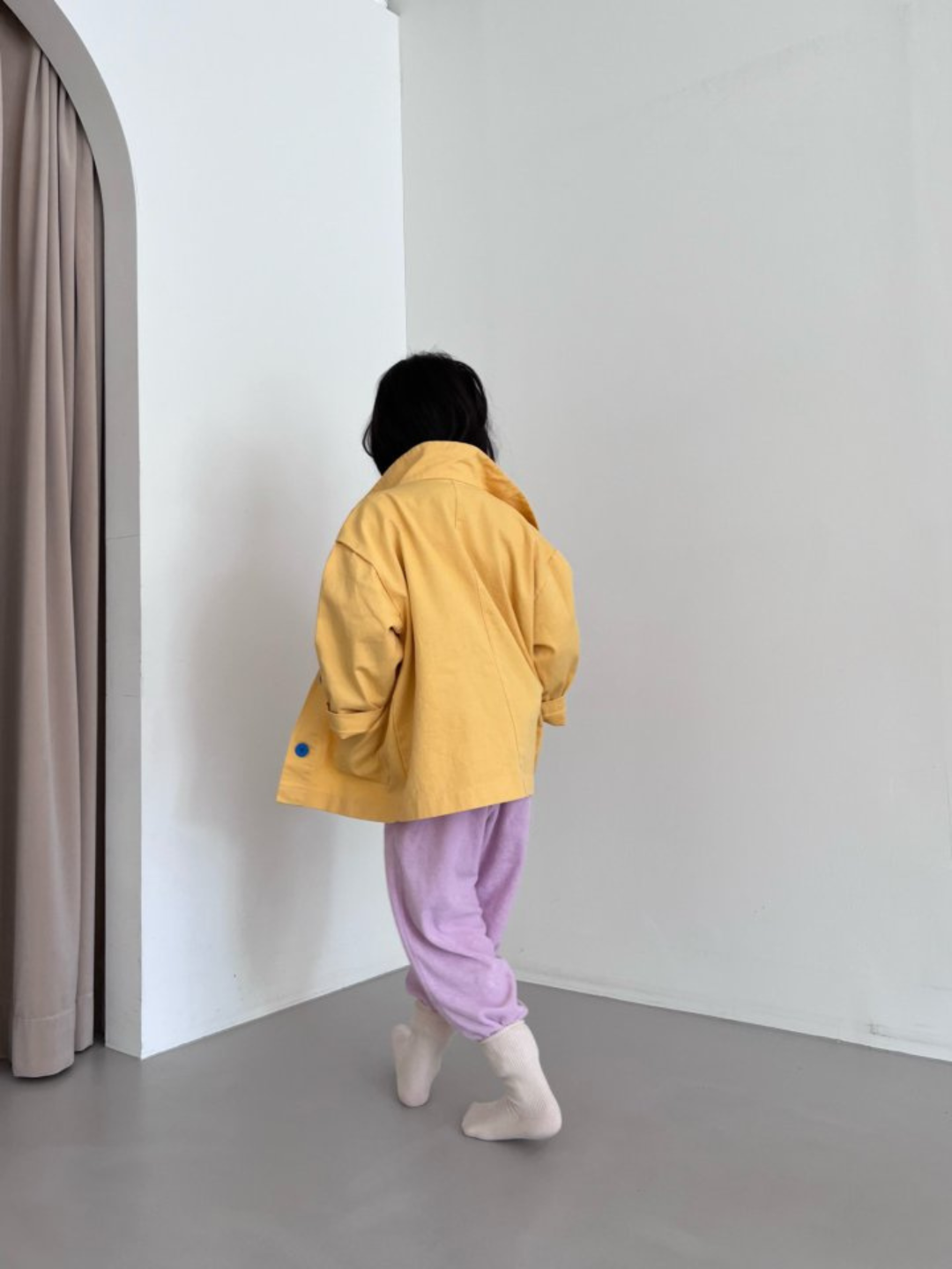 Yellow | A child wearing a kids' jacket in yellow, back view