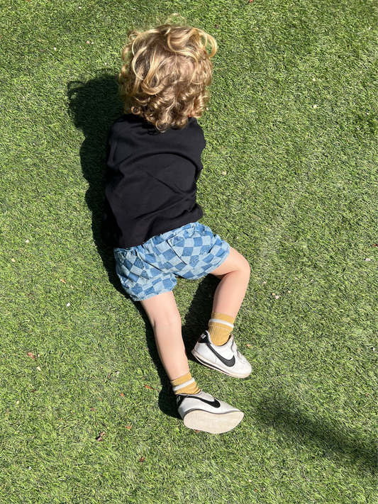 Second image of Pair of kids' checkerboard shorts in two shades of blue, front view