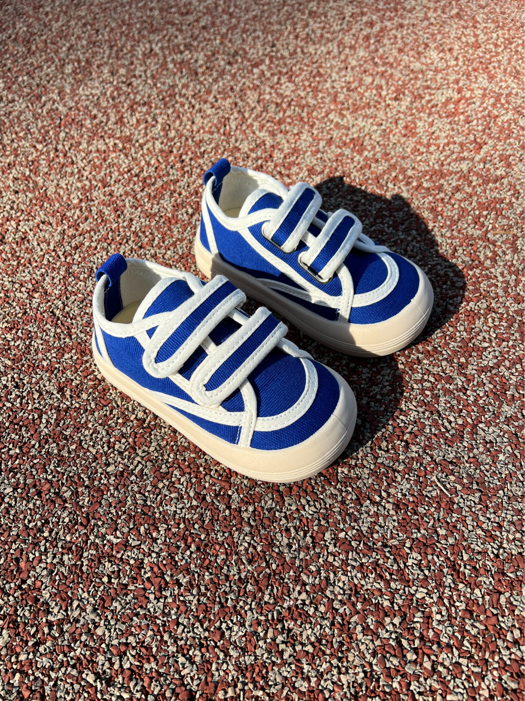 Pair of kids' sneakers in blue with white trim