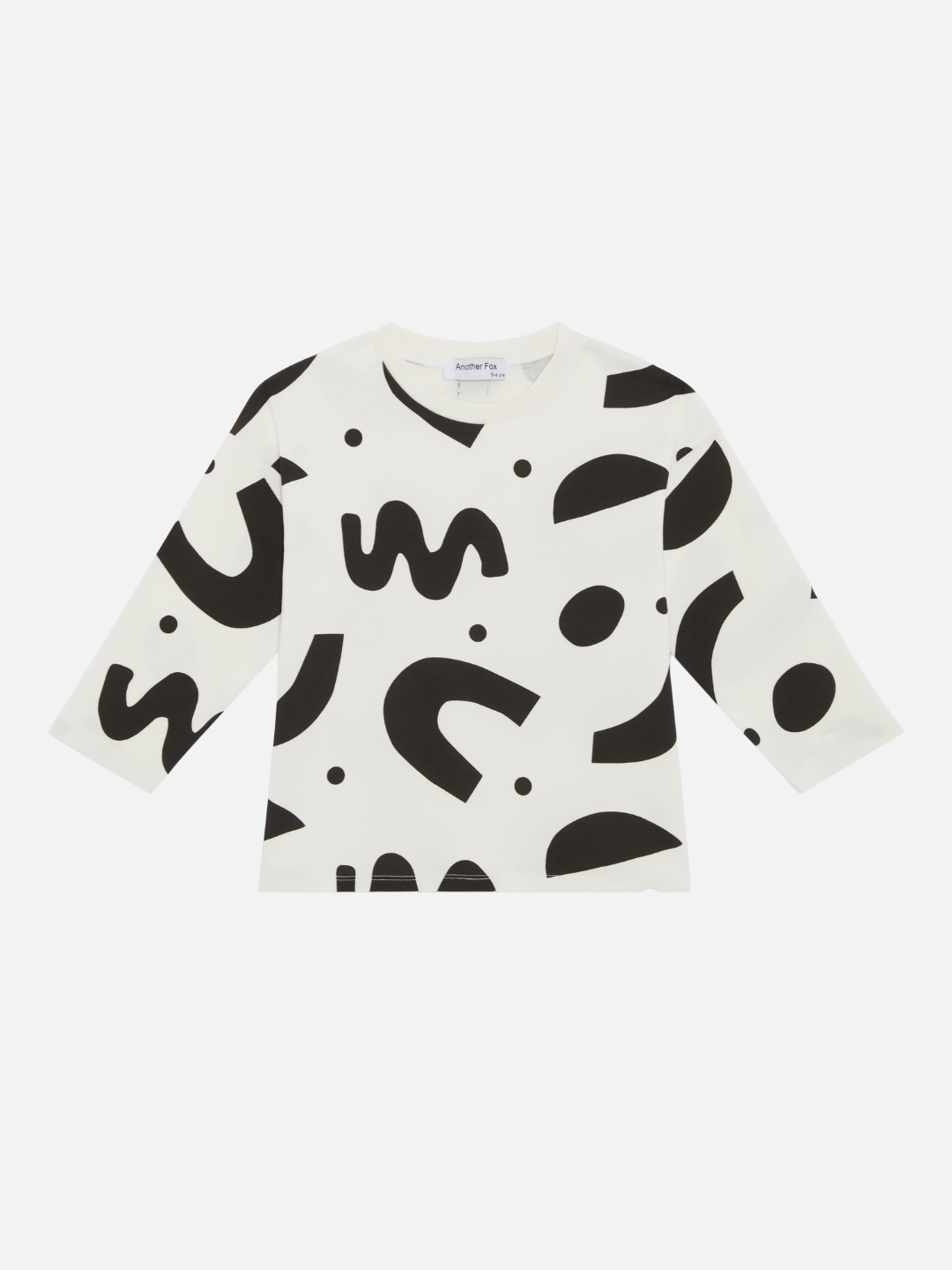 A kids' long-sleeved tee shirt printed with black squiggles and dots on a white background