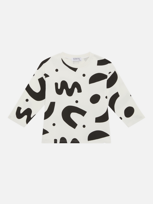 Image of A kids' long-sleeved tee shirt printed with black squiggles and dots on a white background