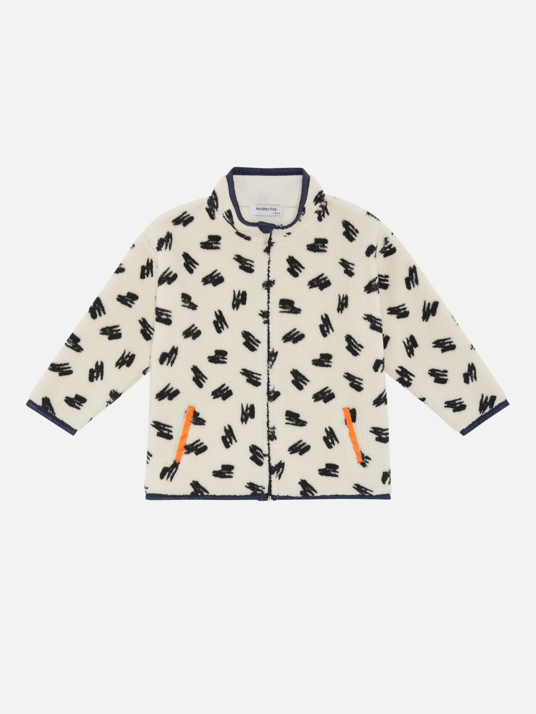 A kids' jacket in a pattern of black scribbles on a cream background with orange pocket  bindings