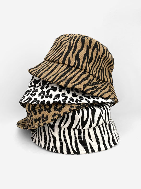 A pile of kids' bucket hats in various animal prints