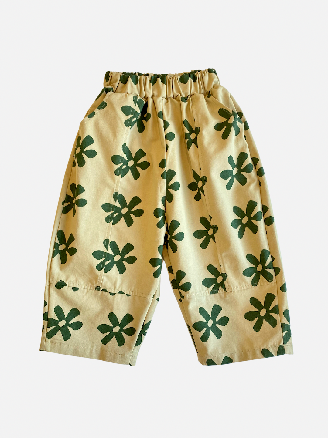 Khaki | A pair of kids' pants in cream with green flowers