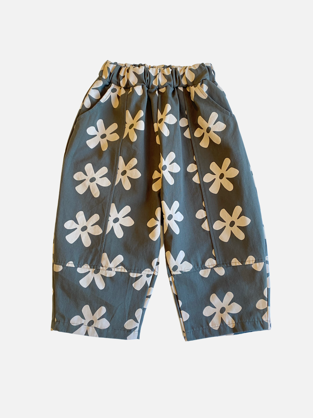 A pair of kids' pants in gray with cream flowers