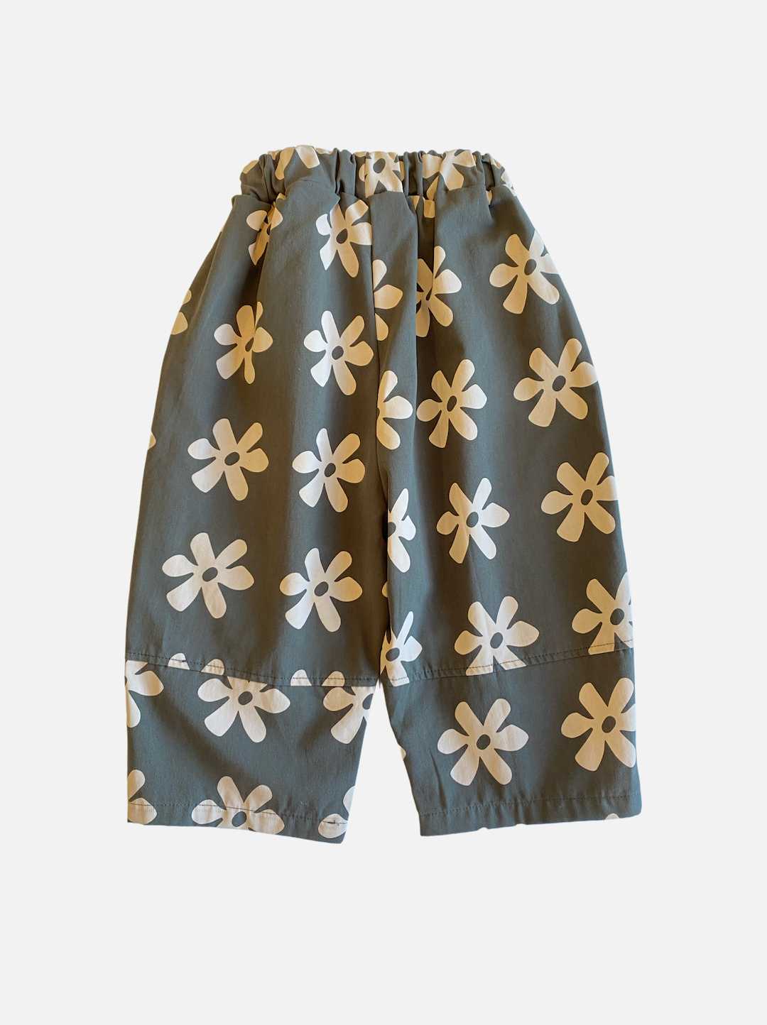 A pair of kids' pants in gray with cream flowers, back view