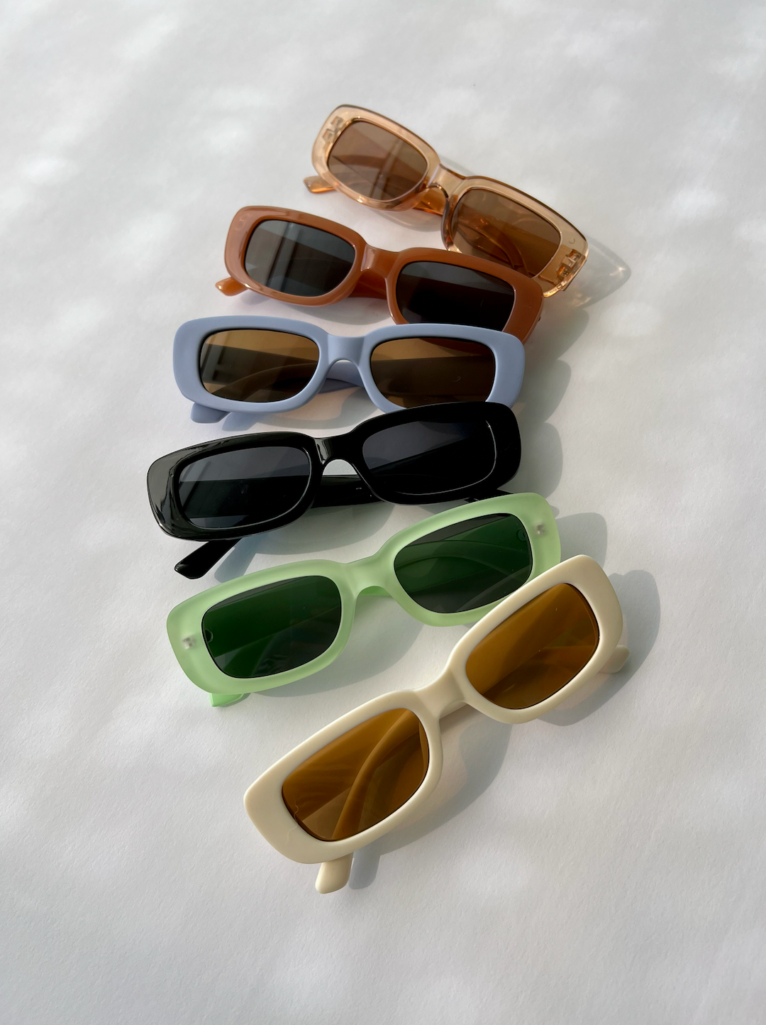 Amber Transparent | An assortment of kids' sunglasses in various colors