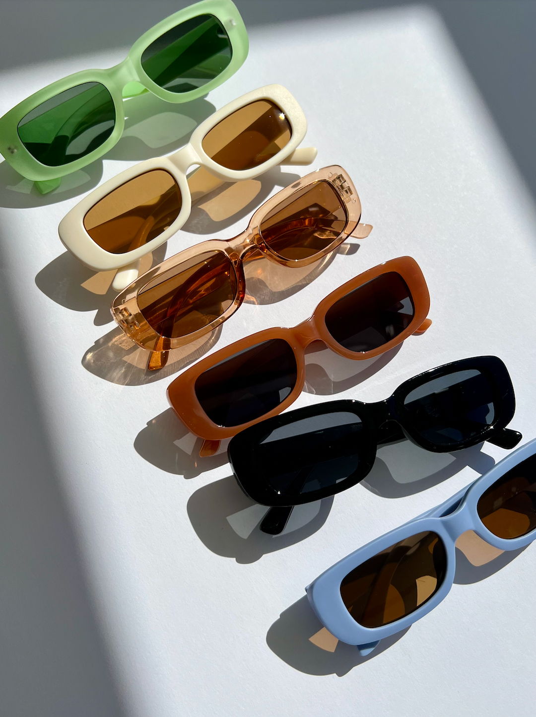 An assortment of kids' sunglasses in various colors