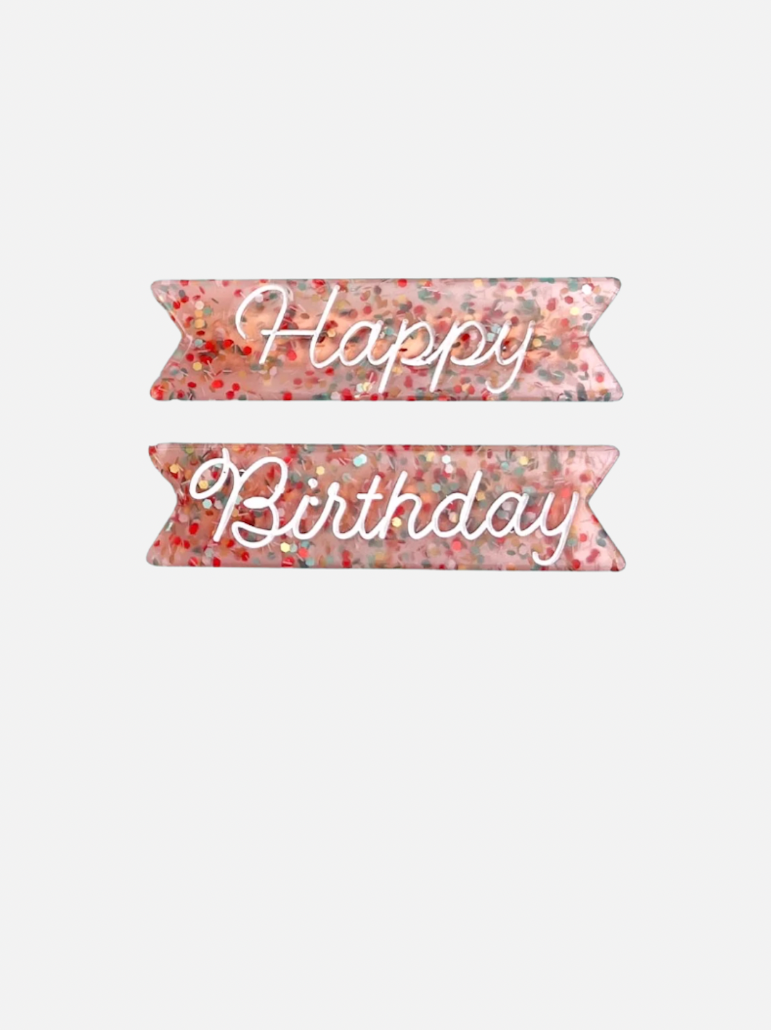 Two kids' barrettes filled with multicolored glitter; one printed with Happy, the other with Birthday